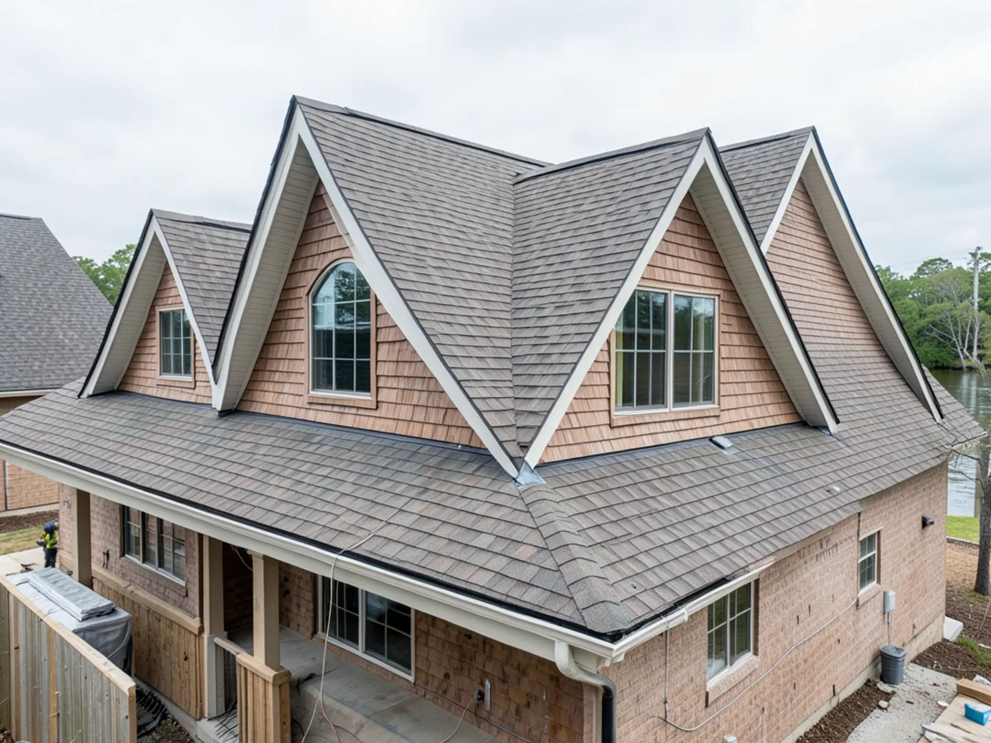 Steep multi-gabled roofline in Towne Lake shedding water into deep 6-inch gutter troughs